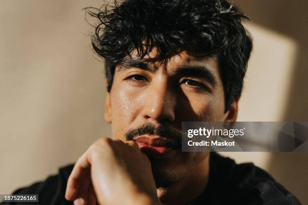 portrait of confident man with messy black hair - imperfection stock pictures, royalty-free photos & images