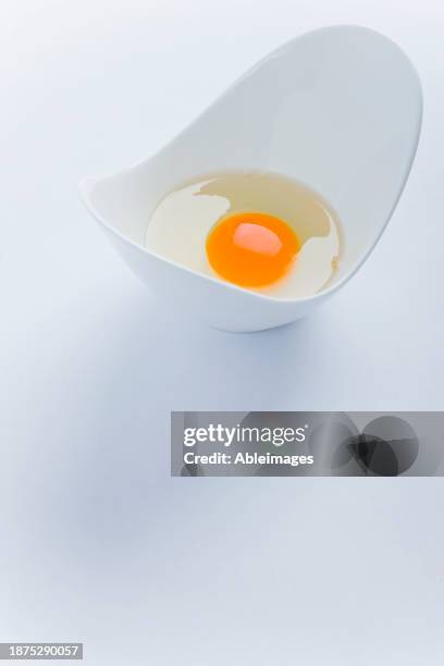 Uncooked Egg In White Container High-Res Stock Photo