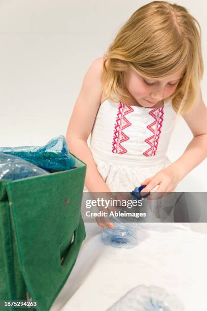 young girl recycling plastic water bottles - trash bag dress stock pictures, royalty-free photos & images
