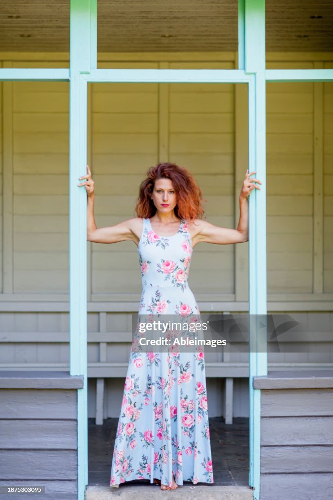 Woman in Floral Dress Standing in Gazebo Doorway