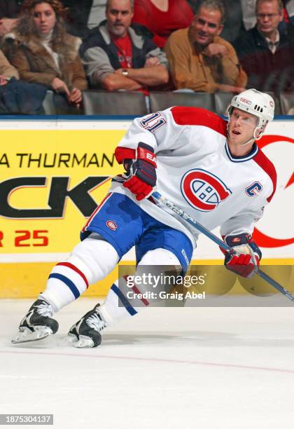 Saku Koivu of the Montreal Canadiens skates against the Toronto Maple Leafs during NHL game action on December 20, 2003 at Air Canada Centre in...