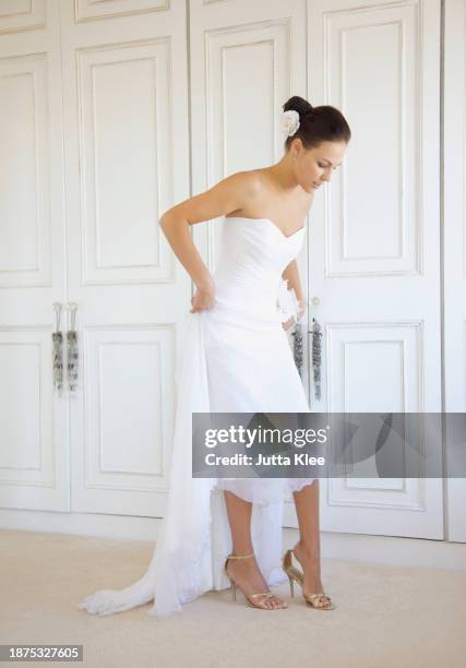 bride putting on shoes - gold shoe stock pictures, royalty-free photos & images