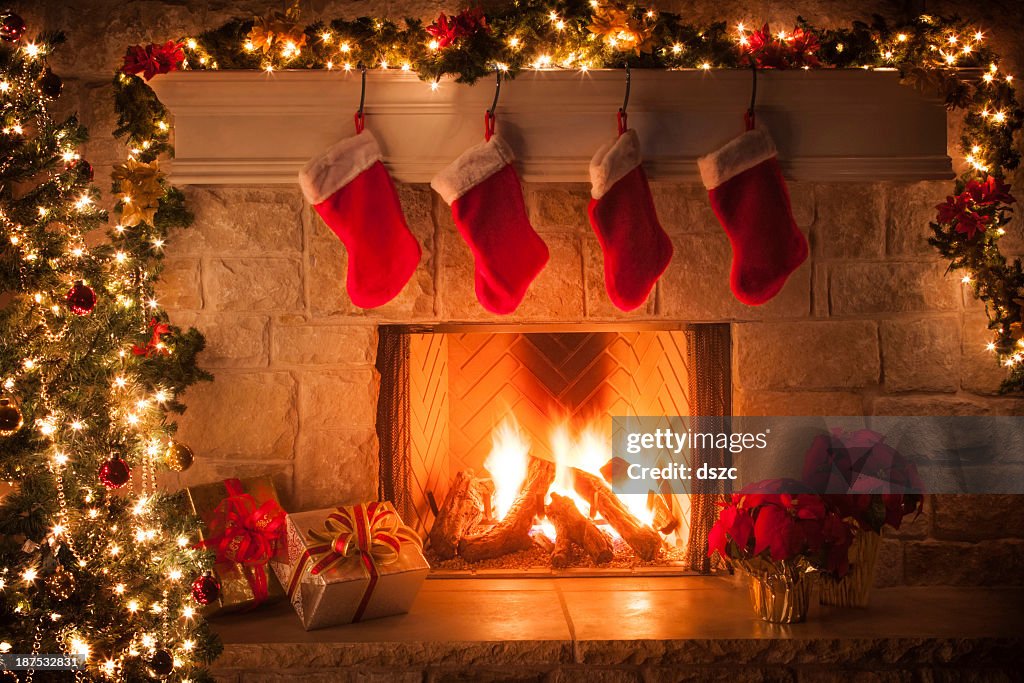 Christmas stockings, fireplace, tree, and decorations