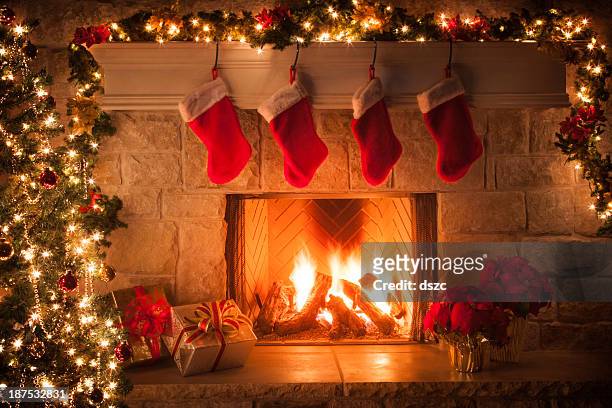 christmas stockings, fireplace, tree, and decorations - fireplace christmas stock pictures, royalty-free photos & images