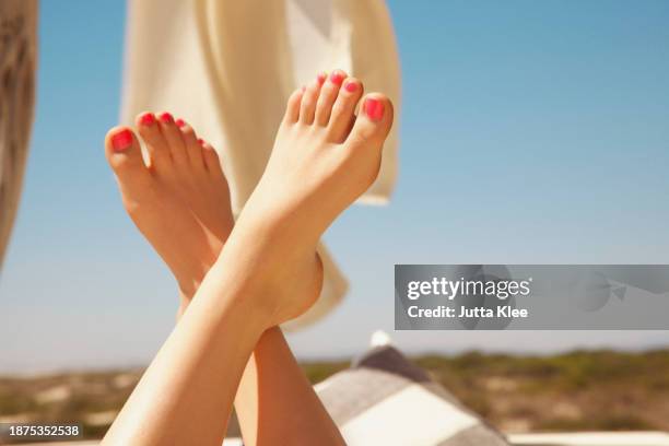 woman's feet in the air with bright pink toenails - foot stock pictures, royalty-free photos & images