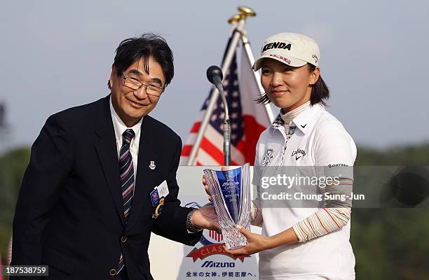 Teresa Lu of Taiwan receives the tournament trophy after the final round of the Mizuno Classic at Kintetsu Kashikojima Country Club on November 10,...