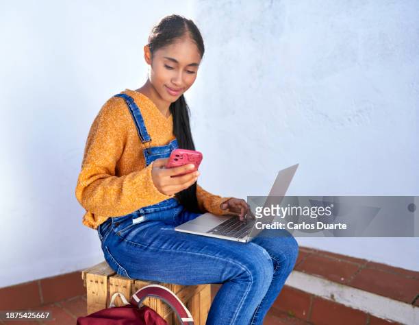 beautiful colombian latin digital nomad girl connected to her laptop consulting her sales in her e-commerce company in a co working center in spain with copy space - co op stock pictures, royalty-free photos & images