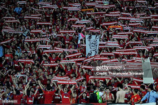 Supporters for Guangzhou Evergrande hold scarves aloft during the AFC Champions League Final 2nd leg match between Guangzhou Evergrande and FC Seoul...