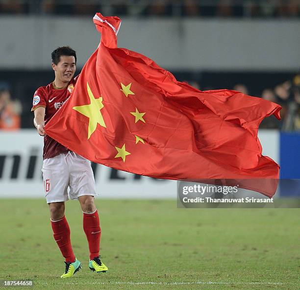 Guangzhou Evergrande player Huang Bowen celebrates with Chinese flag after winning the 2013 AFC Champions League final at Guangzhou Tianhe Sport...