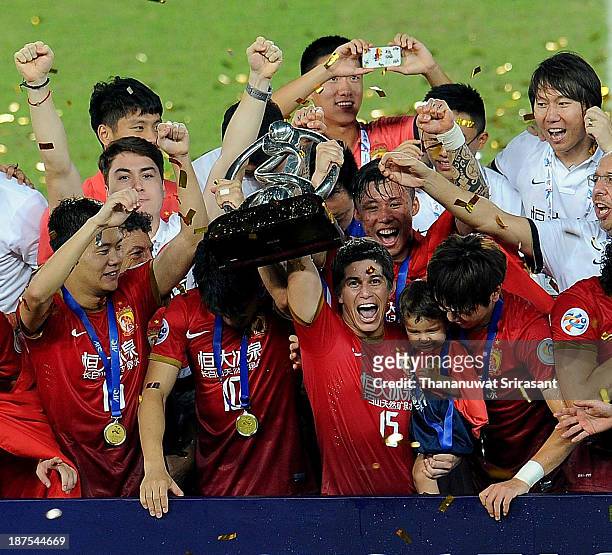 Guangzhou Evergrande player Dario Conca celebrates with the AFC Champions League Final Tropy after winning the 2013 AFC Champions League final at...
