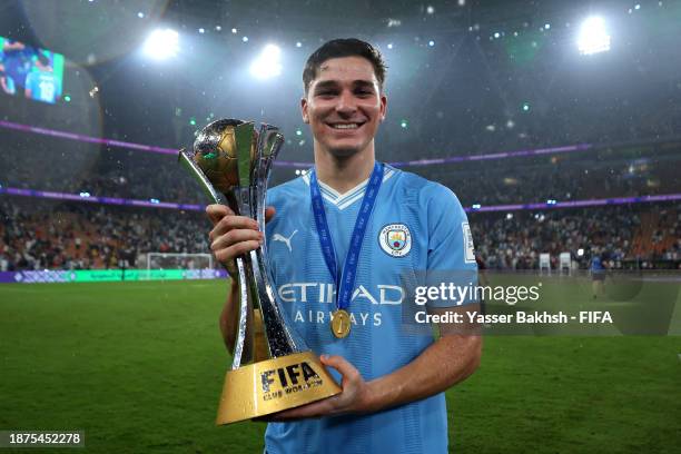 Julian Alvarez of Manchester City poses for a photograph with the FIFA Club World Cup trophy after their team's victory in the FIFA Club World Cup...