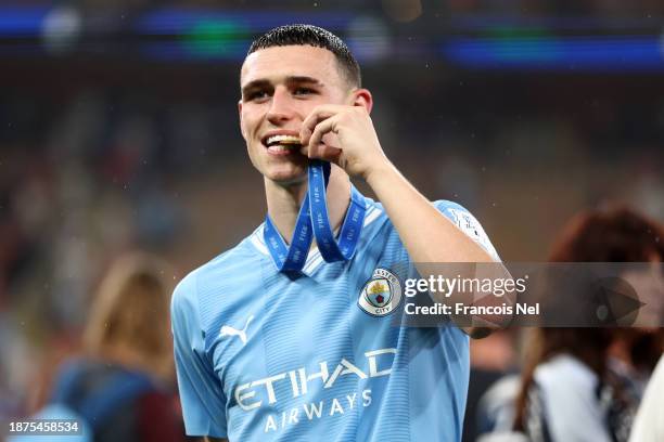 Phil Foden of Manchester City bites their winner's medal after the team's victory in the FIFA Club World Cup Saudi Arabia 2023 Final between...