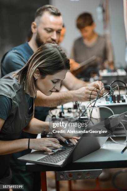 female student learning how to code sequences into plc device through laptop - mobile developer stock pictures, royalty-free photos & images