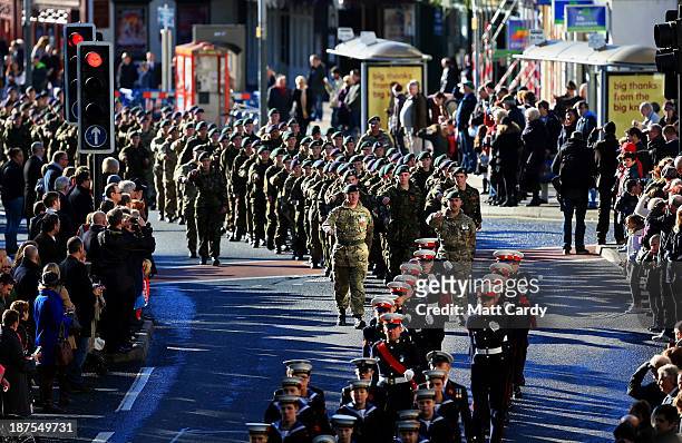 Locals line the street as members of the armed forces and veterans march during a Remembrance Day on November 10, 2013 in Bristol, England. People...