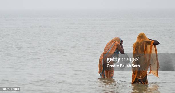 a holy dip at gangasagar - river bathing stock pictures, royalty-free photos & images