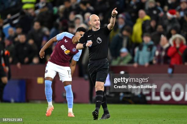 Match Referee Anthony Taylor disallows the first goal scored by Leon Bailey of Aston Villa after checking the Video Assistant Referee screen during...