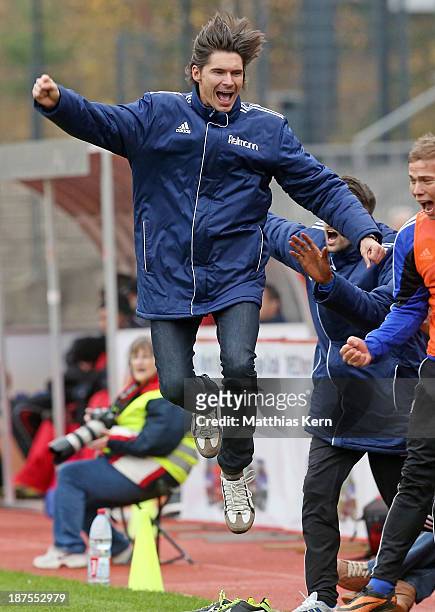 Head coach Thomas Brdaric of Neustrelitz jubilates after Velimir Jovanovic scoring the second goal during the Regionalliga Nordost match between...