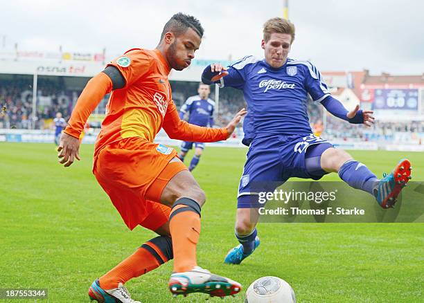 Phil Ofosu-Ayeh of Duisburg competes for the ball with Michael Hohnstedt of Osnabrueck during the Third League match between between VfL Osnabrueck...