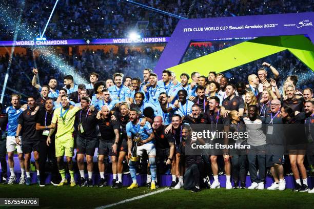 Players and staffs of Manchester City celebrate the victory with the trophy following the FIFA Club World Cup Final between Manchester City and...
