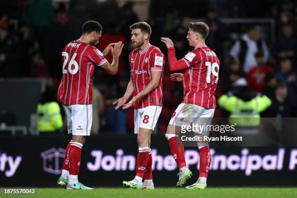 Zak Vyner, Joe Williams and George Tanner of Bristol City celebrate after the team's victory in the Sky Bet Championship match between Bristol City...