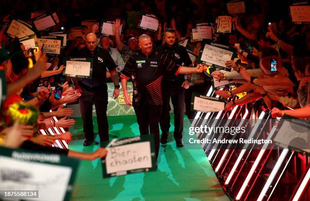 Raymond van Barneveld of The Netherlands makes his way to the stage during Day Eight of the 2023/24 Paddy Power World Darts Championship at Alexandra...