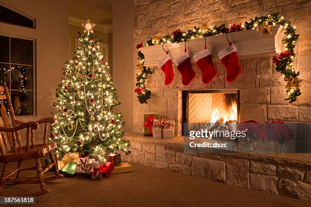 christmas stockings, fireplace, tree, and decorations - house with christmas lights stock pictures, royalty-free photos & images