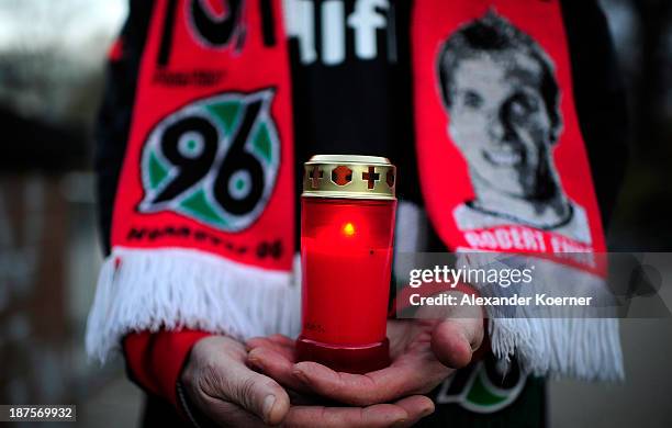Candle is being held by a fan of German Bundesliga soccer club Hannover 96 in front of HDI Arena on the fourth anniversary of the death of the club's...