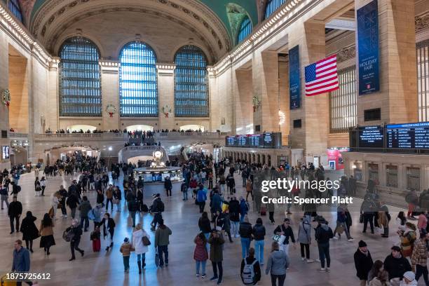 People walk through Grand Central Terminal in midtown Manhattan only days before the Christmas holiday on December 22, 2023 in New York City. New...