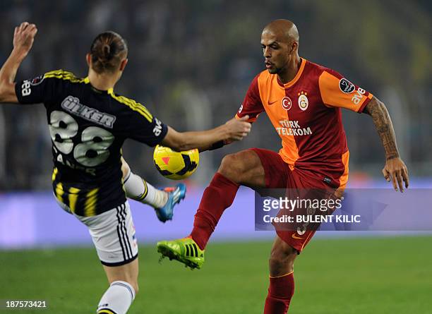 Fenerbahce's Caner Erkin fights for the ball with Galatasaray's Felipe Melo during the Turkish Super League football match between Fenerbahce and...