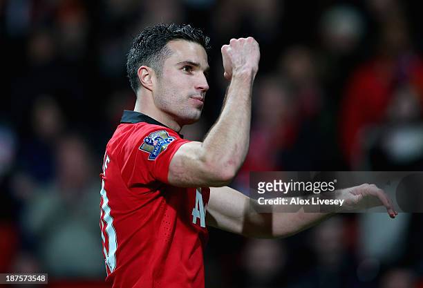 Robin van Persie of Manchester United celebrates at the end of the Barclays Premier League match between Manchester United and Arsenal at Old...