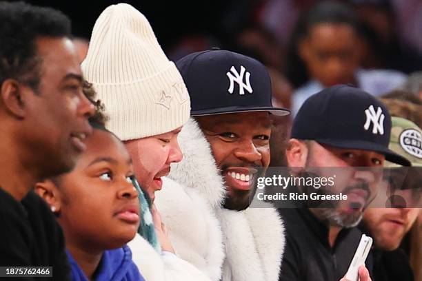 Rapper/Actor 50 Cent sits at celebrity row next to Rapper Fat Joe and Chris Rock at Madison Square Garden on December 25, 2023 in New York City. NOTE...
