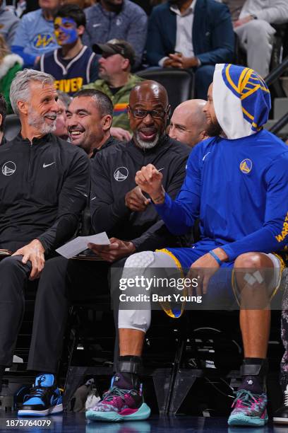 Assistant Coach Kris Weems and Stephen Curry of the Golden State Warriors smile during the game against the Denver Nuggets on December 25, 2023 at...