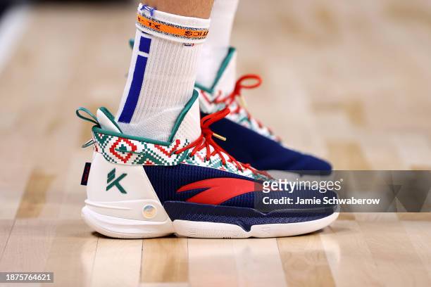 Klay Thompson of the Golden State Warriors wears shoes with a Christmas pattern against the Denver Nuggets at Ball Arena on December 25, 2023 in...