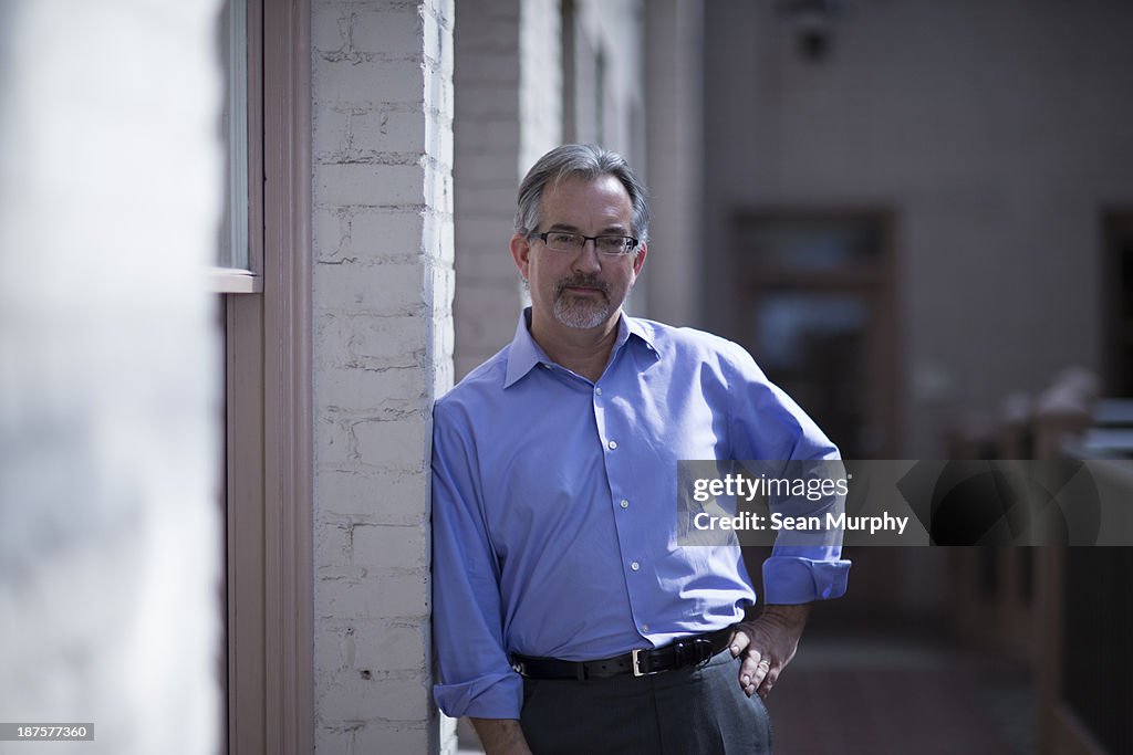 Man in business attire standing in hall