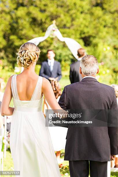 man and bride walking down the aisle during wedding ceremony - bride walking stock pictures, royalty-free photos & images