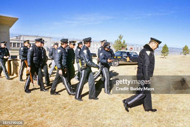 Large contingent of New Mexico State Police brought in to help quell the riots at the New Mexico State Penitentiary leaves the facility the morning...