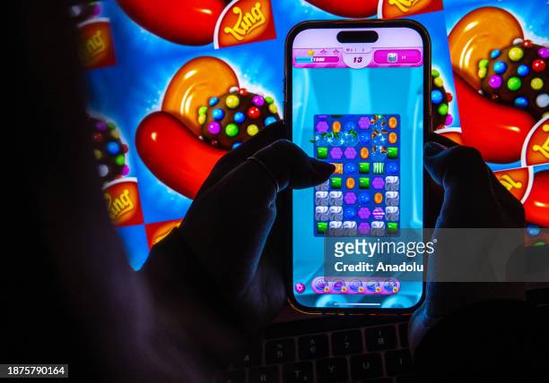 In this photo illustration, the visual of Candy Crush Saga game is displayed on a mobile phone screen and computer screen in Ankara, Turkiye on...