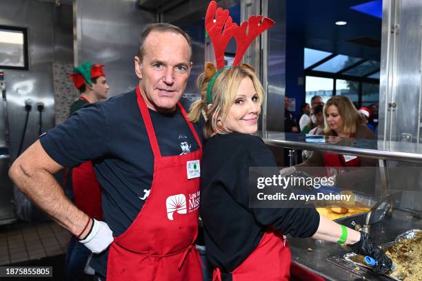 Clark Gregg and Emma Caulfield volunteer at the Los Angeles Mission's 87th Annual Christmas Celebration at Los Angeles Mission on December 22, 2023...