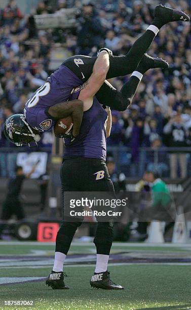 Wide receiver Torrey Smith of the Baltimore Ravens is picked up by teammate Marshal Yanda after catching a second quarter touchdown pass against the...