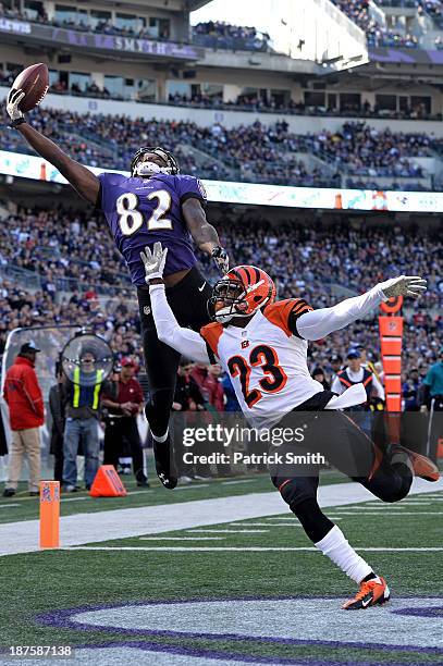 Wide receiver Torrey Smith of the Baltimore Ravens tries to catch a pass as he is defended by cornerback Terence Newman of the Cincinnati Bengals in...
