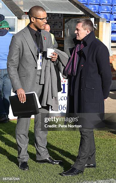 Presenter Clarke Carlise talks to his former manager at Northampton Town Aidy Boothroyd before the FA Cup with Budweiser match between Bishop's...