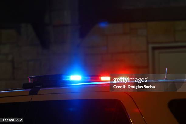 closeup of police car lights on a night time traffic stop - police car driving stock pictures, royalty-free photos & images