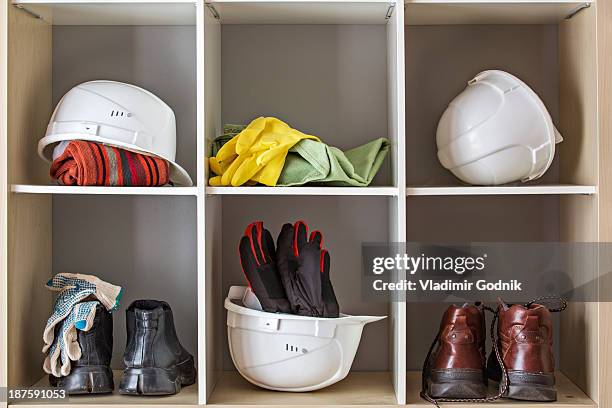 storage of protective headwear, footwear and gloves - protective workwear imagens e fotografias de stock