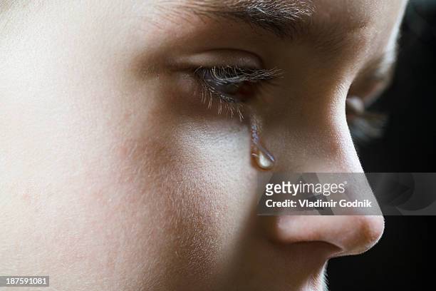 close-up of a girl shedding a tear - lágrima fotografías e imágenes de stock