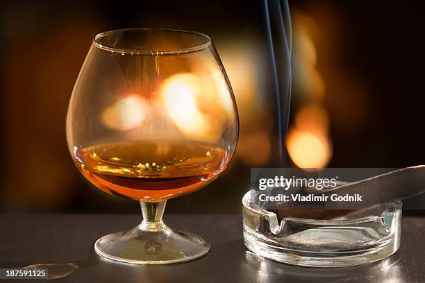 brandy glass and cigar - brandy snifter stock pictures, royalty-free photos & images