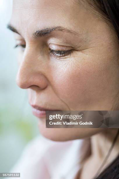 pensive woman looking down - face down stock-fotos und bilder
