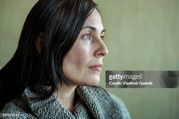 pensive woman looking into distance - ausdruckslos stock-fotos und bilder