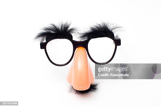 groucho marx novelty glasses on a white background - mask disguise stock-fotos und bilder