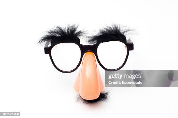 groucho marx novelty glasses on a white background - nose mask fotografías e imágenes de stock