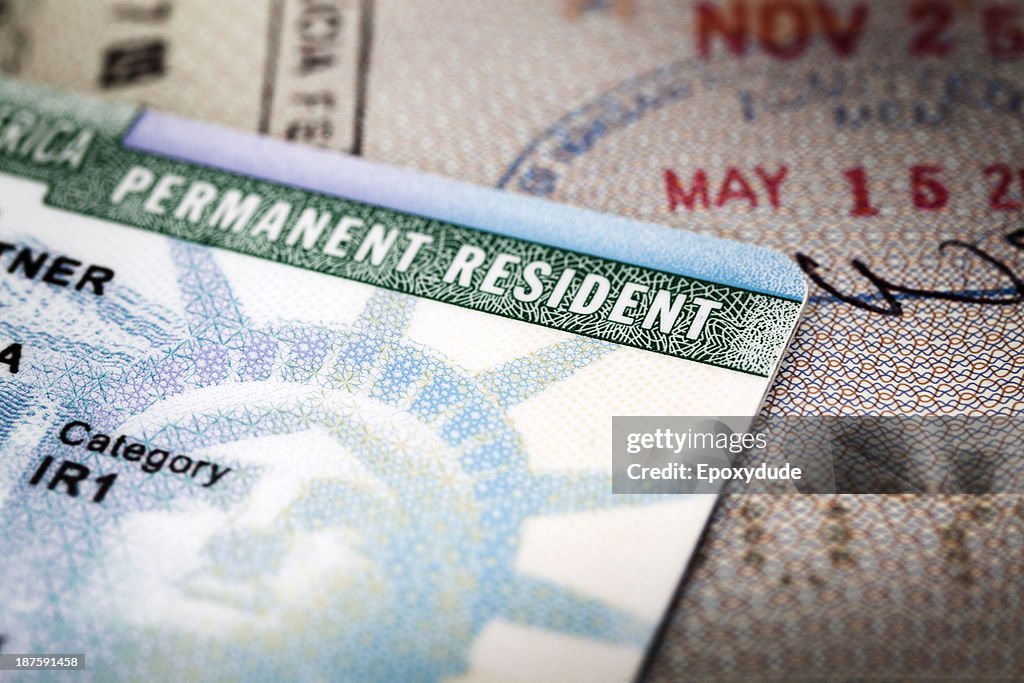 A Green Card lying on an open passport, close-up, full frame